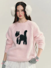 Person wearing a pink sweater with a black cat design, white earmuffs, and white skirt.