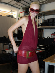 Person wearing a red outfit with a gold belt in an indoor setting