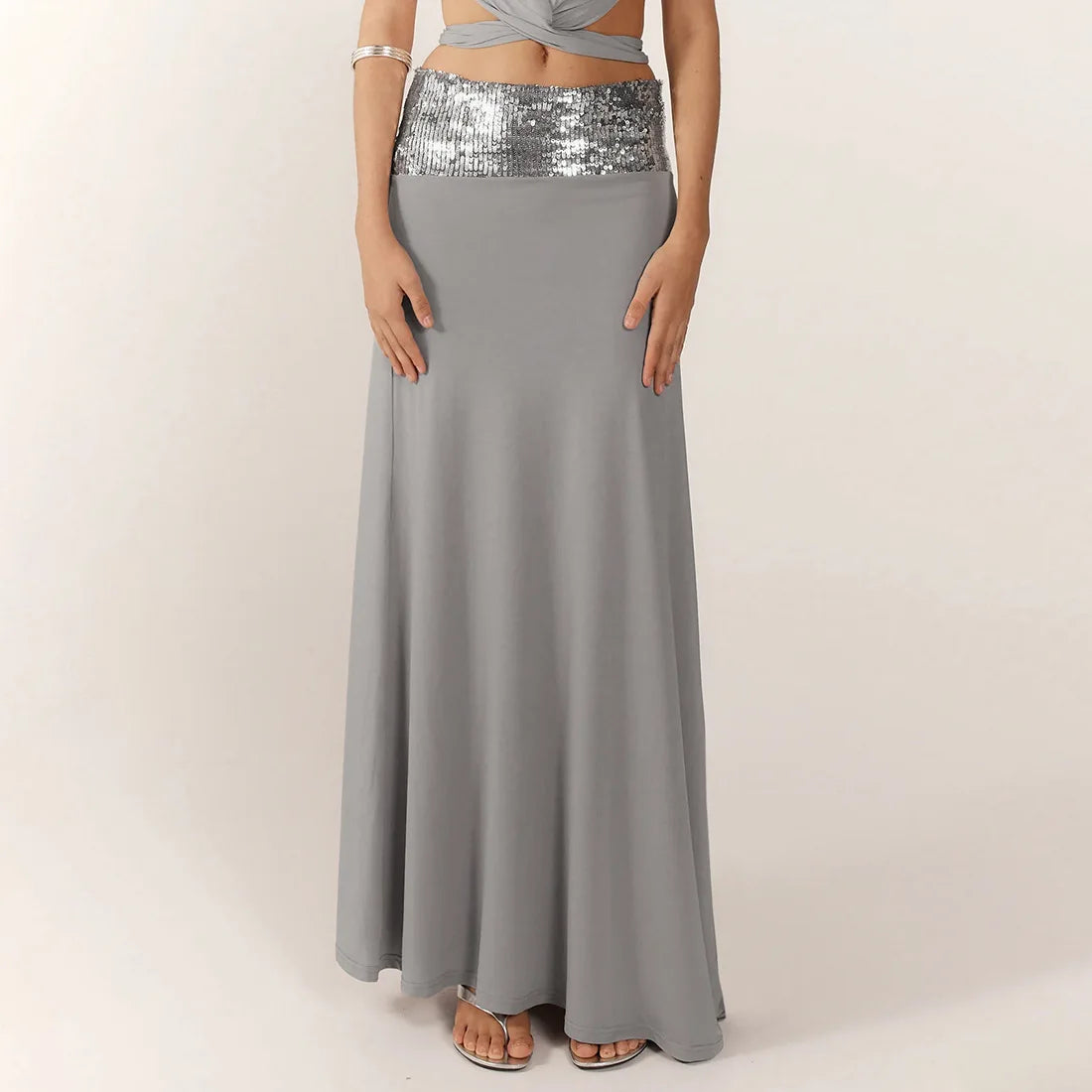 Gray maxi skirt with silver sequin waistband on a plain background
