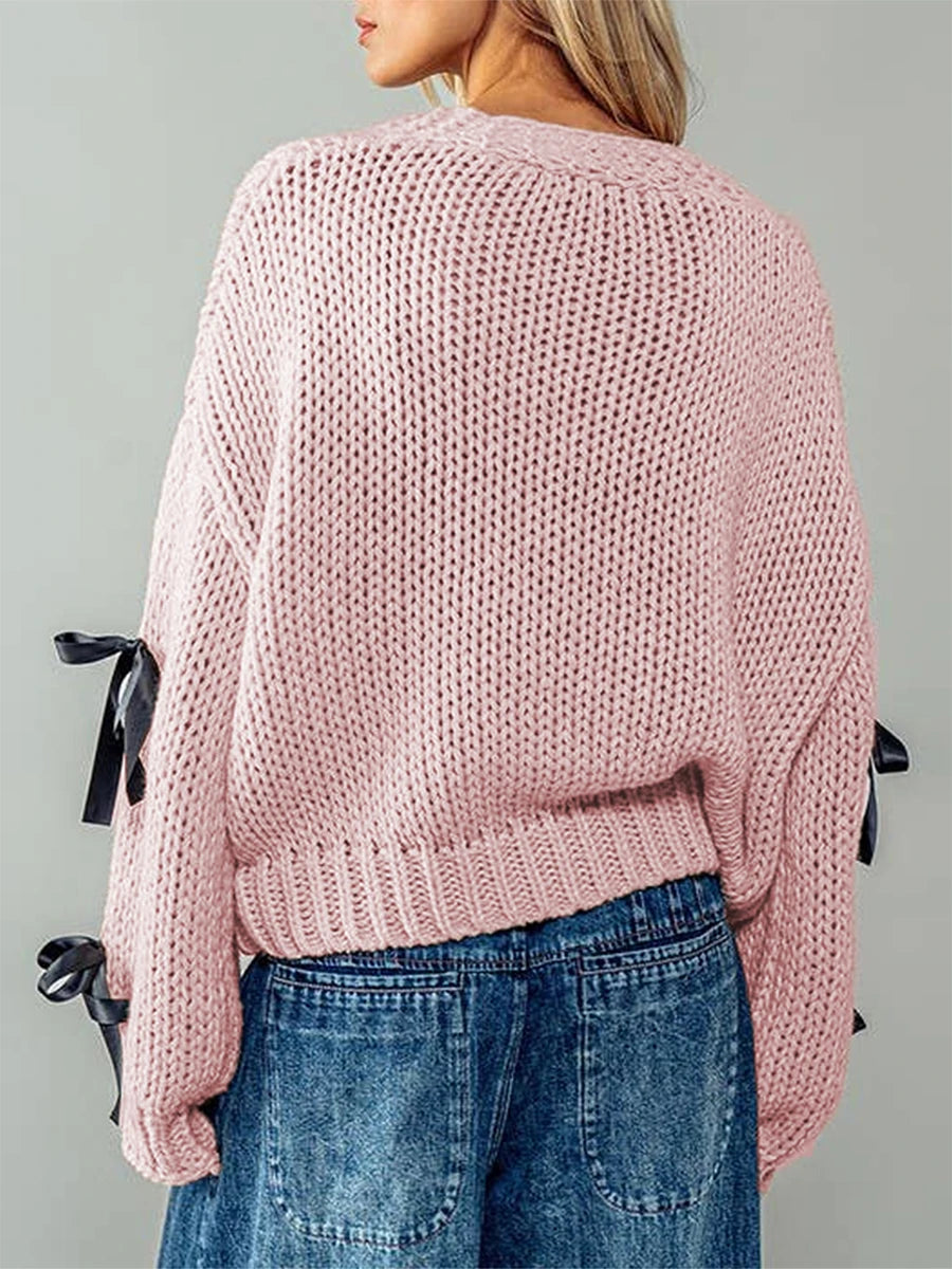 Pink knitted sweater with black ribbons- back