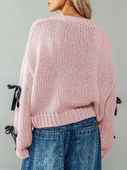 Pink knitted sweater with black ribbons- back