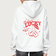 White hoodie with red 'Feeling Lucky' text and dice design on the back, worn by a person.
