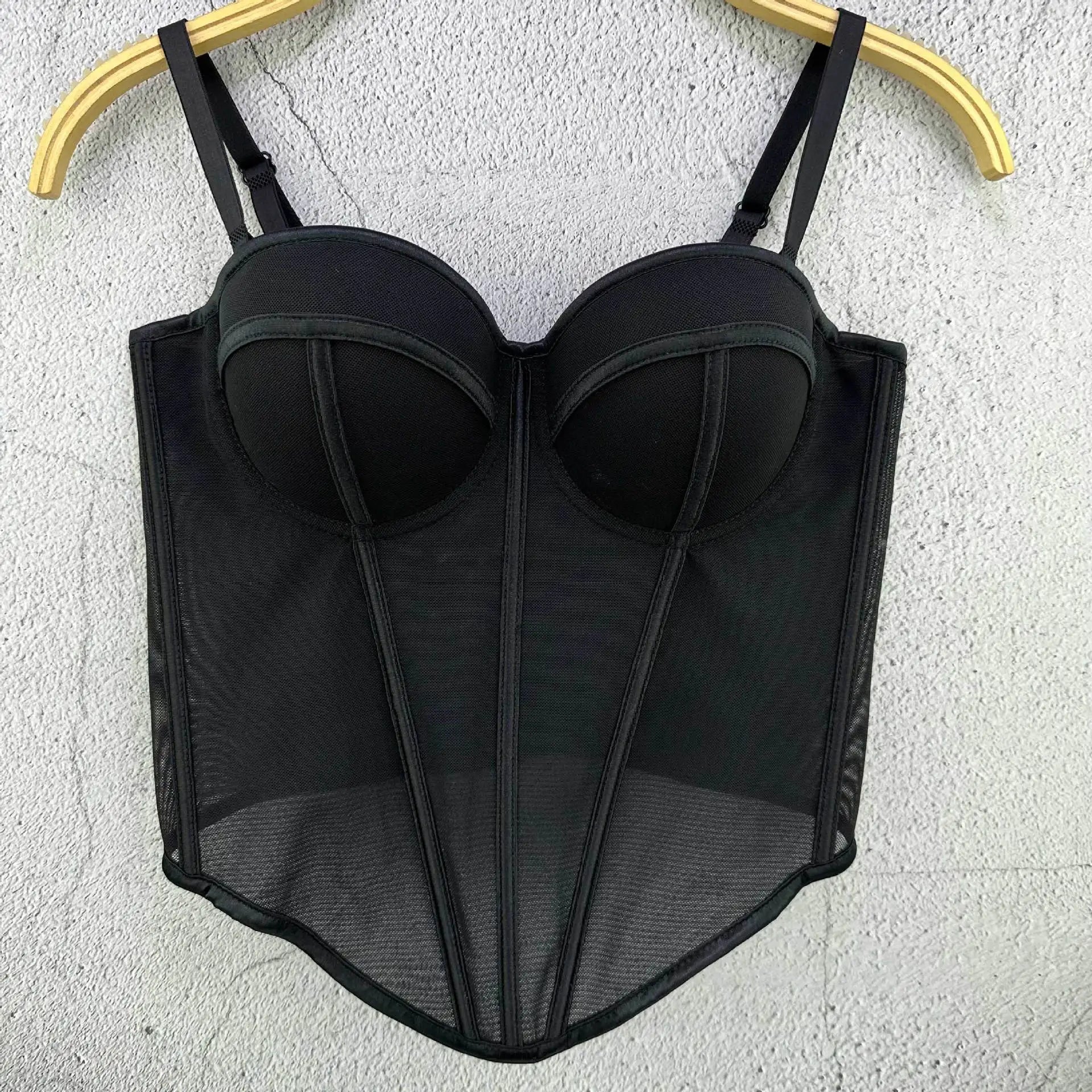 Black mesh lingerie set on a hanger against a light gray background