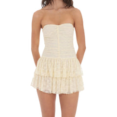 Woman wearing a strapless, ruffled cream dress- styled