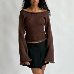 Woman wearing a brown ribbed sweater with long sleeves