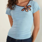 Light blue t-shirt with brown decorative accents worn by a model-close-up