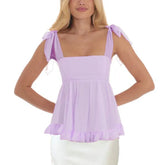 Woman wearing a light purple top with sheer sleeves