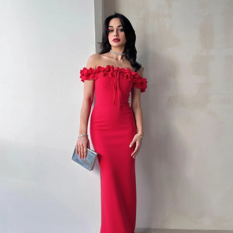 Woman wearing a red off-shoulder dress against a plain background