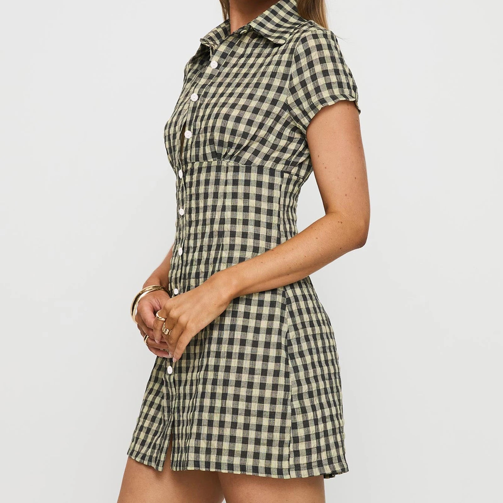 Person wearing a checkered dress on a plain background