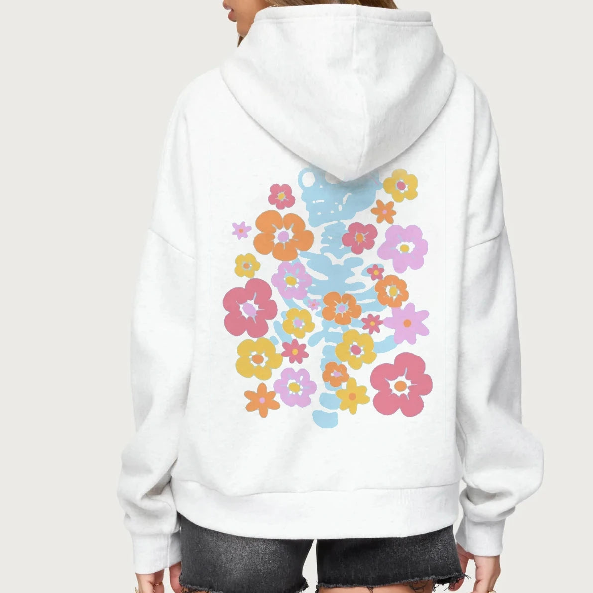 White hoodie with colorful floral design on the back against a white background