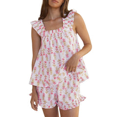 Woman wearing a pink floral dress with ruffled sleeves