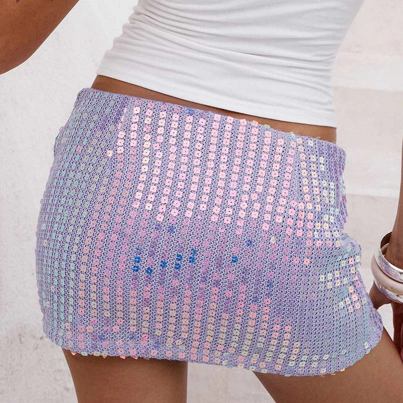 Person wearing a colorful sequin skirt with a plain background