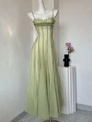 Light green evening gown on a mannequin against a plain background