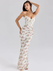 Woman wearing a floral dress on a plain background