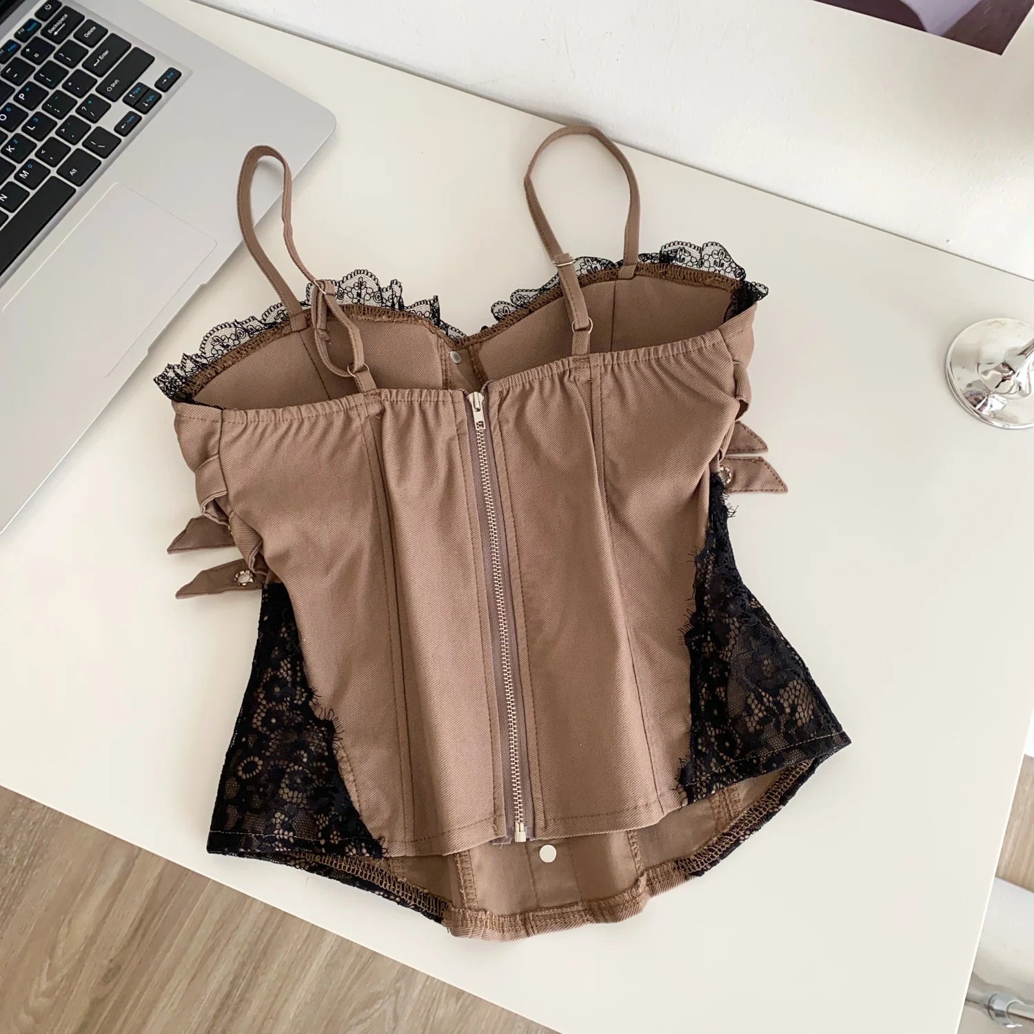 Brown lingerie with lace details on a white surface- back side
