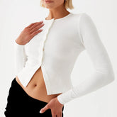 Model displaying a ribbed button long sleeve top with an O-neck and asymmetrical button detailing, showcasing its Y2K style.