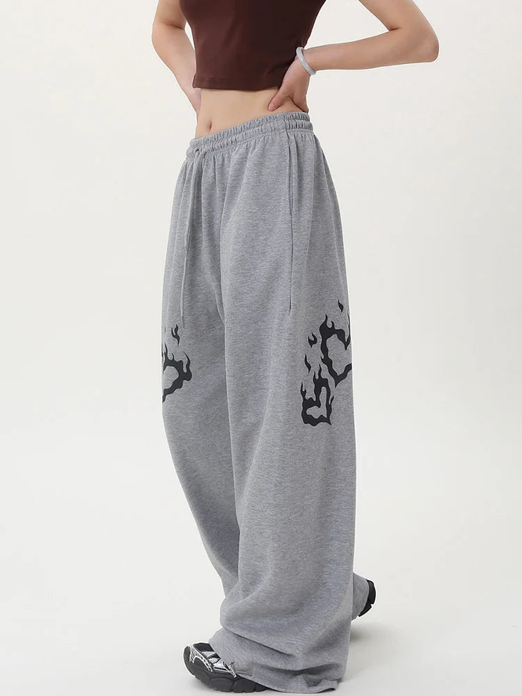 Gray sweatpants with black designs worn by a person