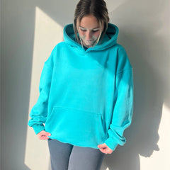 Person wearing a bright blue hoodie against a plain background