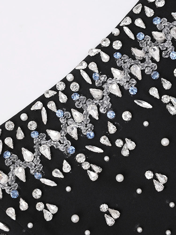 Black fabric with silver and blue embellishments on a white background