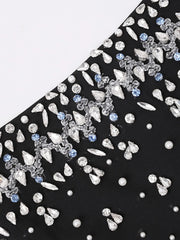 Black fabric with silver and blue embellishments on a white background