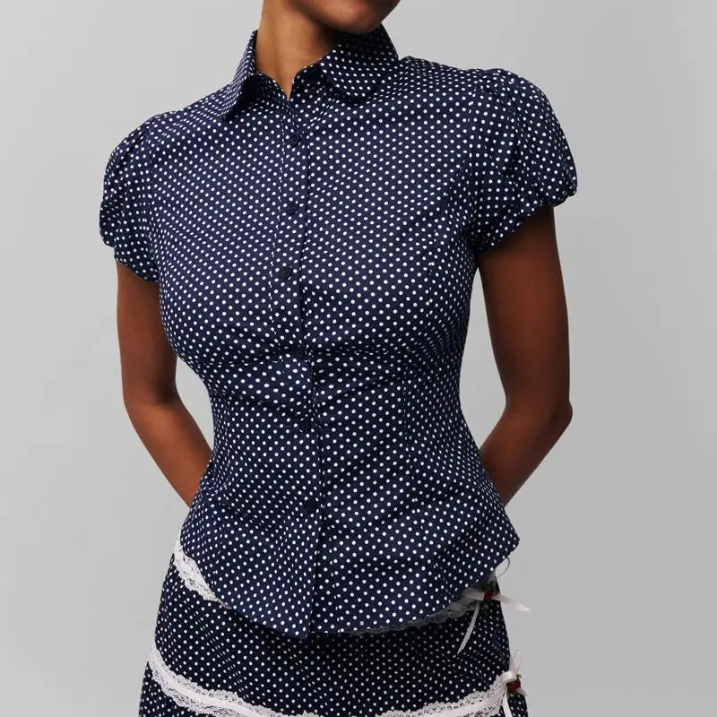 Women's polka dot button down lapel top with puff sleeves.