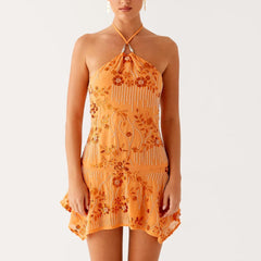 Woman wearing an orange floral dress with beading