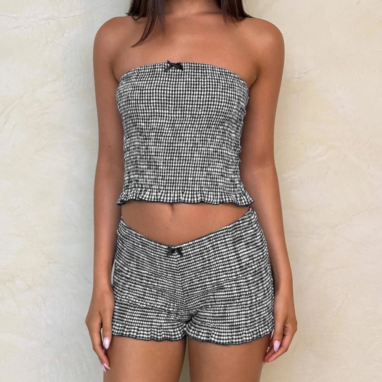 Women's black plaid smocked tube top and matching shorts set.