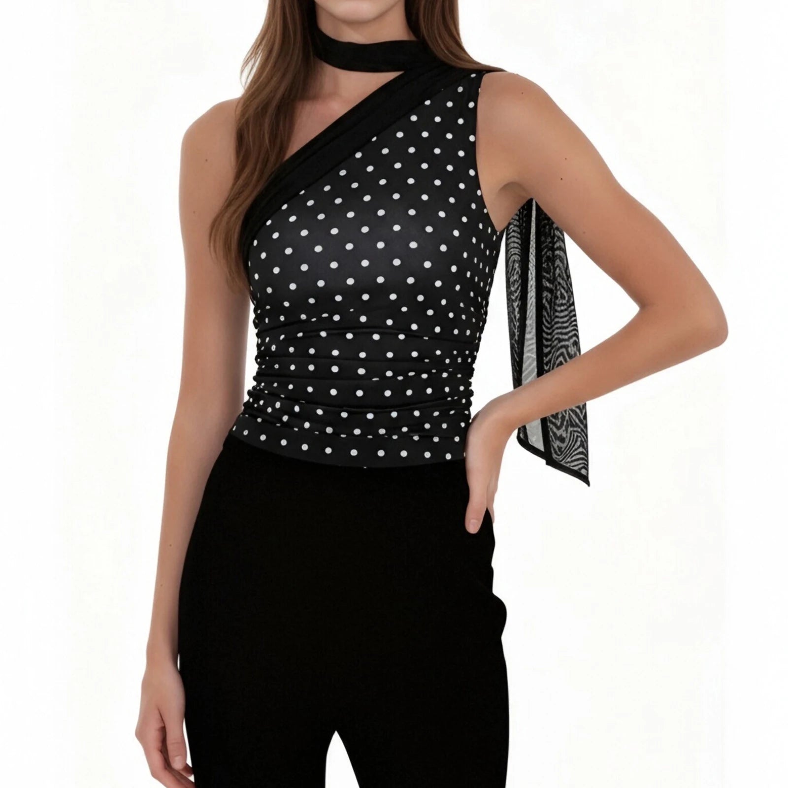 Woman wearing a black polka dot top with a white background