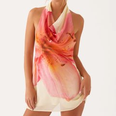 Woman wearing a colorful scarf with a floral design