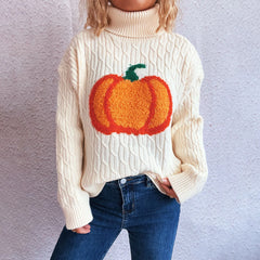 Person wearing a cream sweater with a pumpkin design