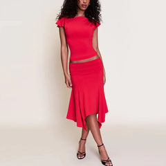 Woman wearing a red dress against a beige background