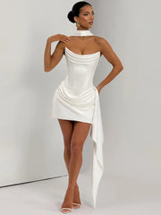Woman wearing a white dress with a draped design