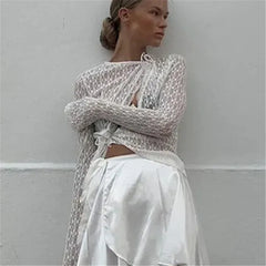 Woman wearing a textured long-sleeve top and white pants 