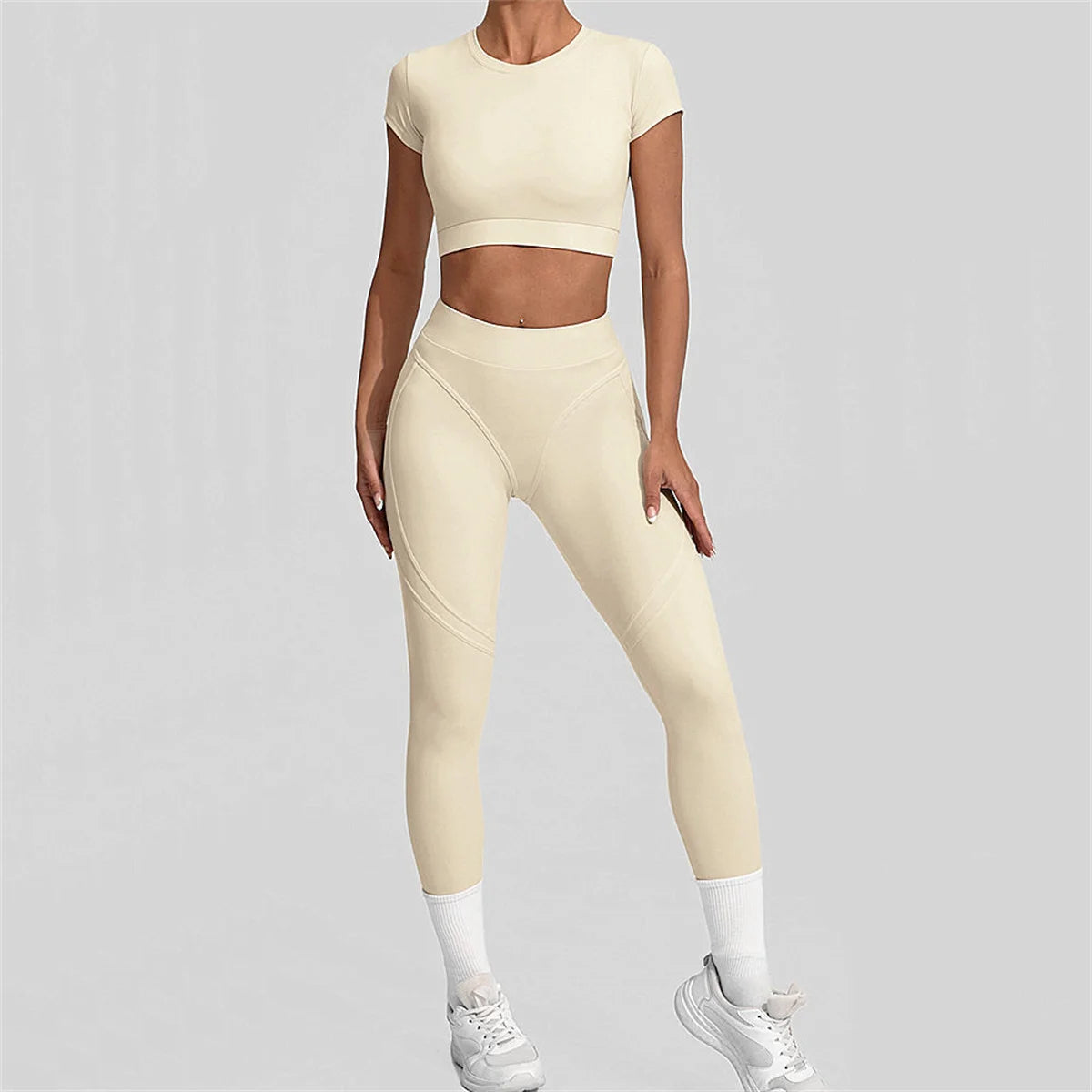 Person wearing a beige athletic outfit on a gray background