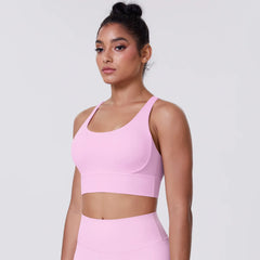 Woman wearing a pink sports bra and leggings- full view
