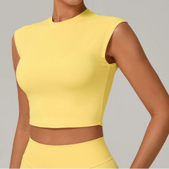 Yellow sleeveless top worn by a person on a gray background