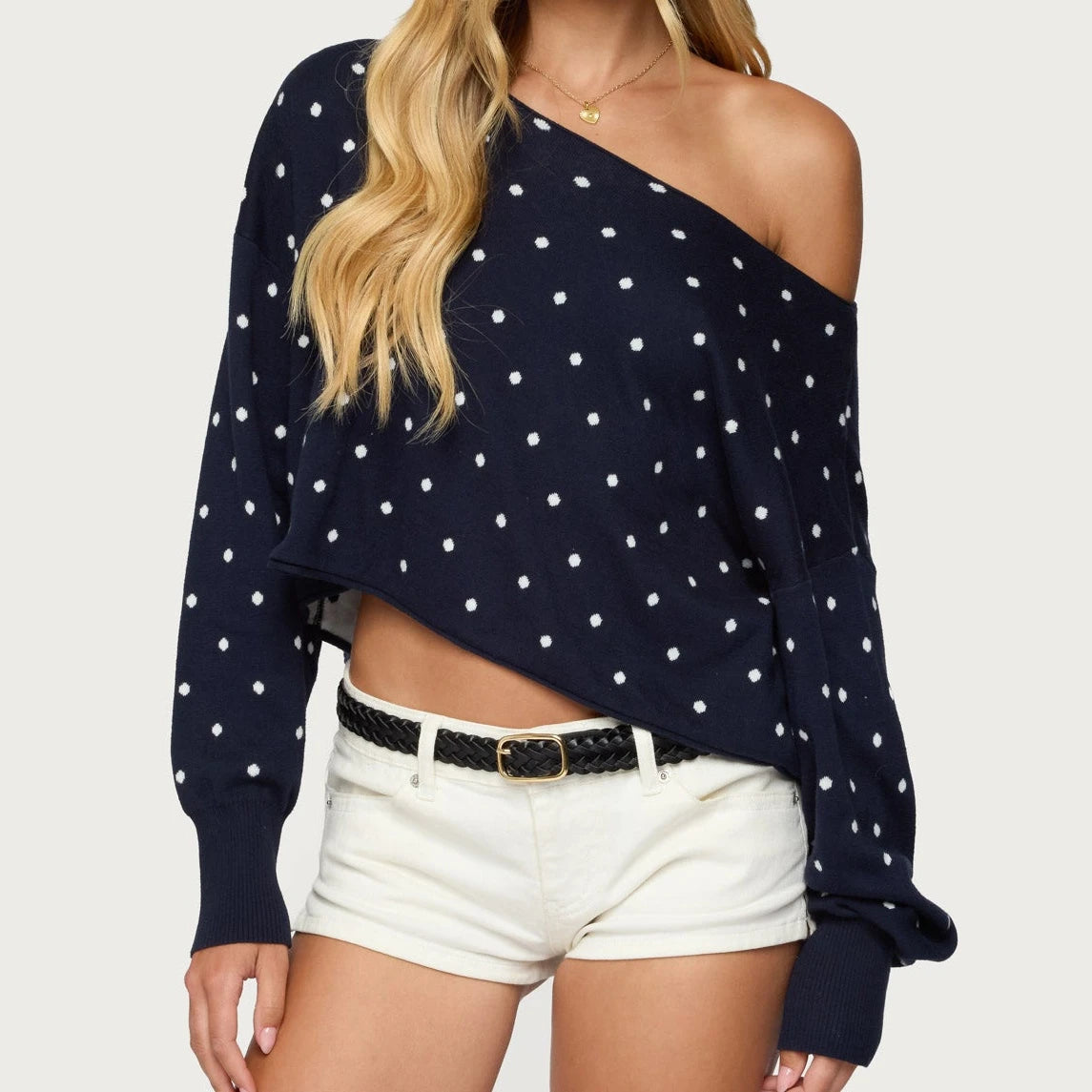 Navy blue polka dot sweater with one shoulder worn by a person -front