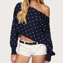 Navy blue polka dot sweater with one shoulder worn by a person -front