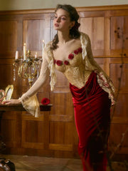Woman in a vintage-style dress with floral details in a wooden interior setting