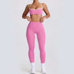 Person wearing a pink sports bra and leggings set 