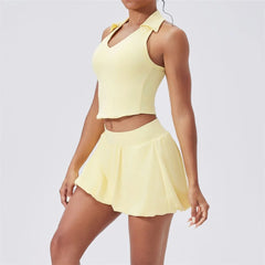 Person wearing a yellow tennis outfit on a plain background