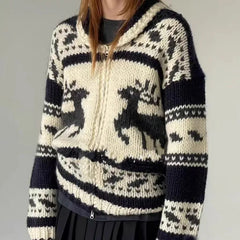 Person wearing a black and white patterned sweater with deer design 