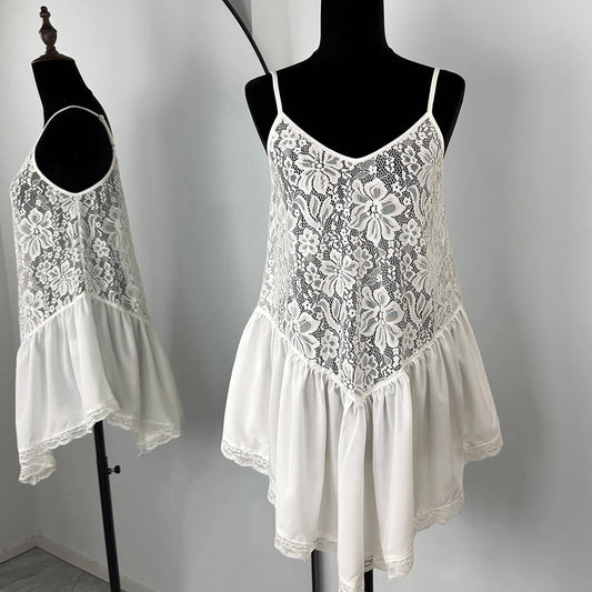 White lace dress on a mannequin against a plain background