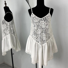 White lace dress on a mannequin against a plain background