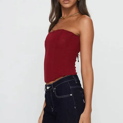 Woman wearing a red strapless top and black jeans - side view