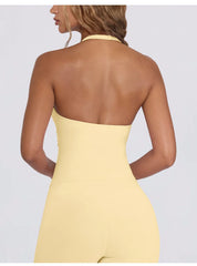Yellow halter neck dress on a plain background