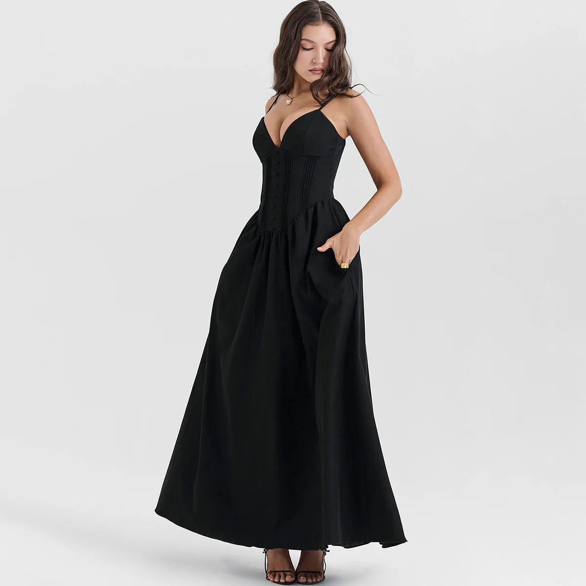 A woman wearing a flattering black maxi dress with a flowing silhouette, perfect for a special occasion or a night out.