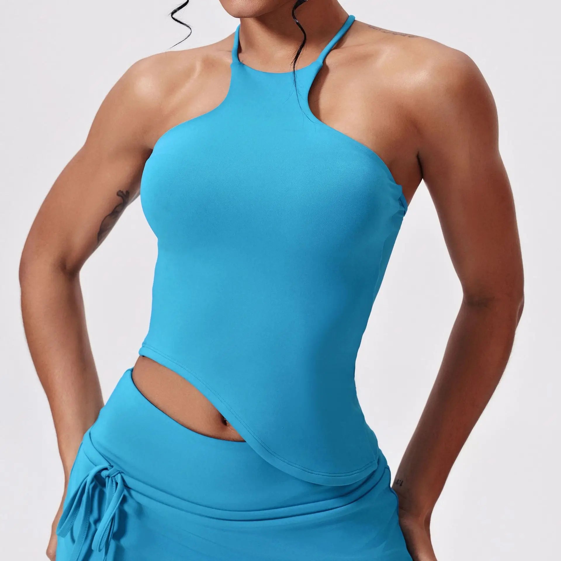 Person wearing a blue tank top with cut-out design front view