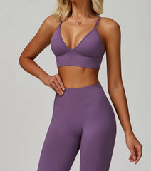 Person wearing a purple sports bra and leggings 