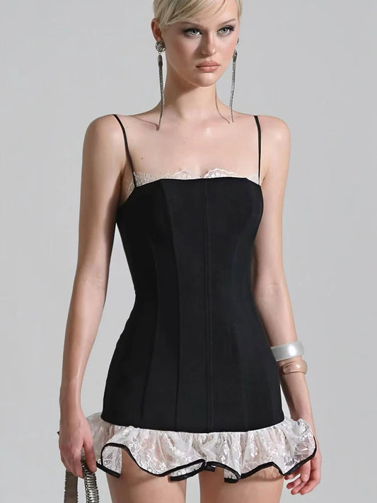 Woman wearing a black corset with white lace trim on a gray background